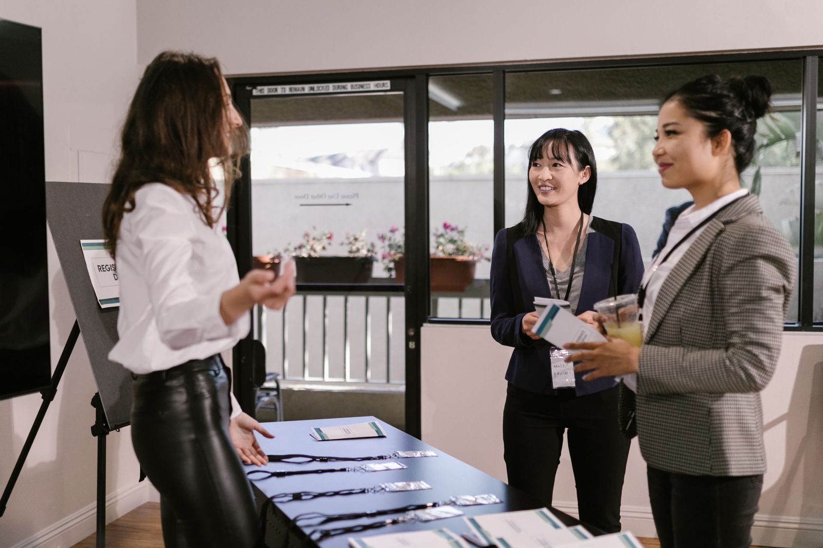 An event check-in desk with badges and printed lists laid out for arrivals