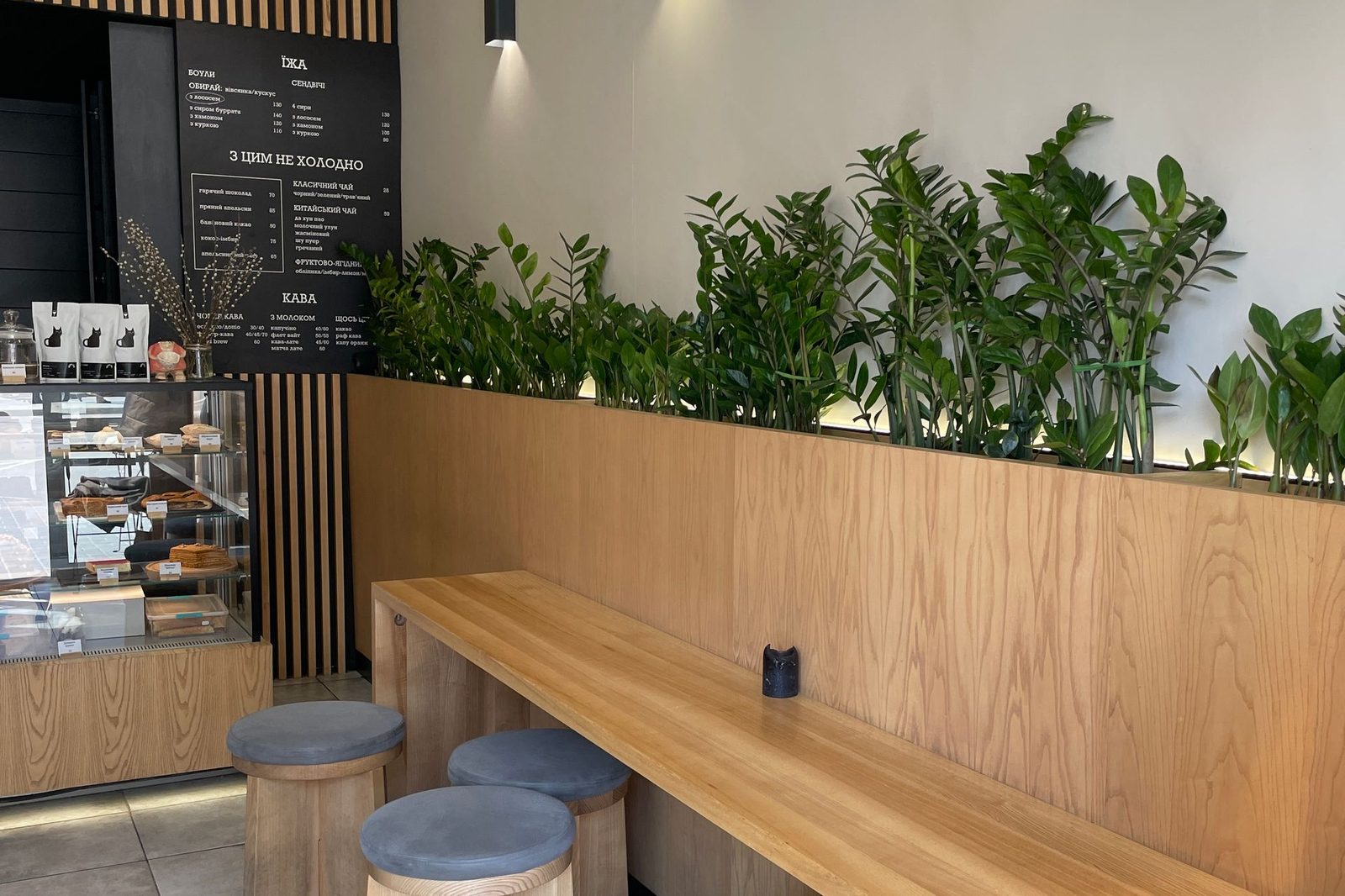 Empty café interior with wooden chairs stacked and arranged around small tables, waiting for people to arrive
