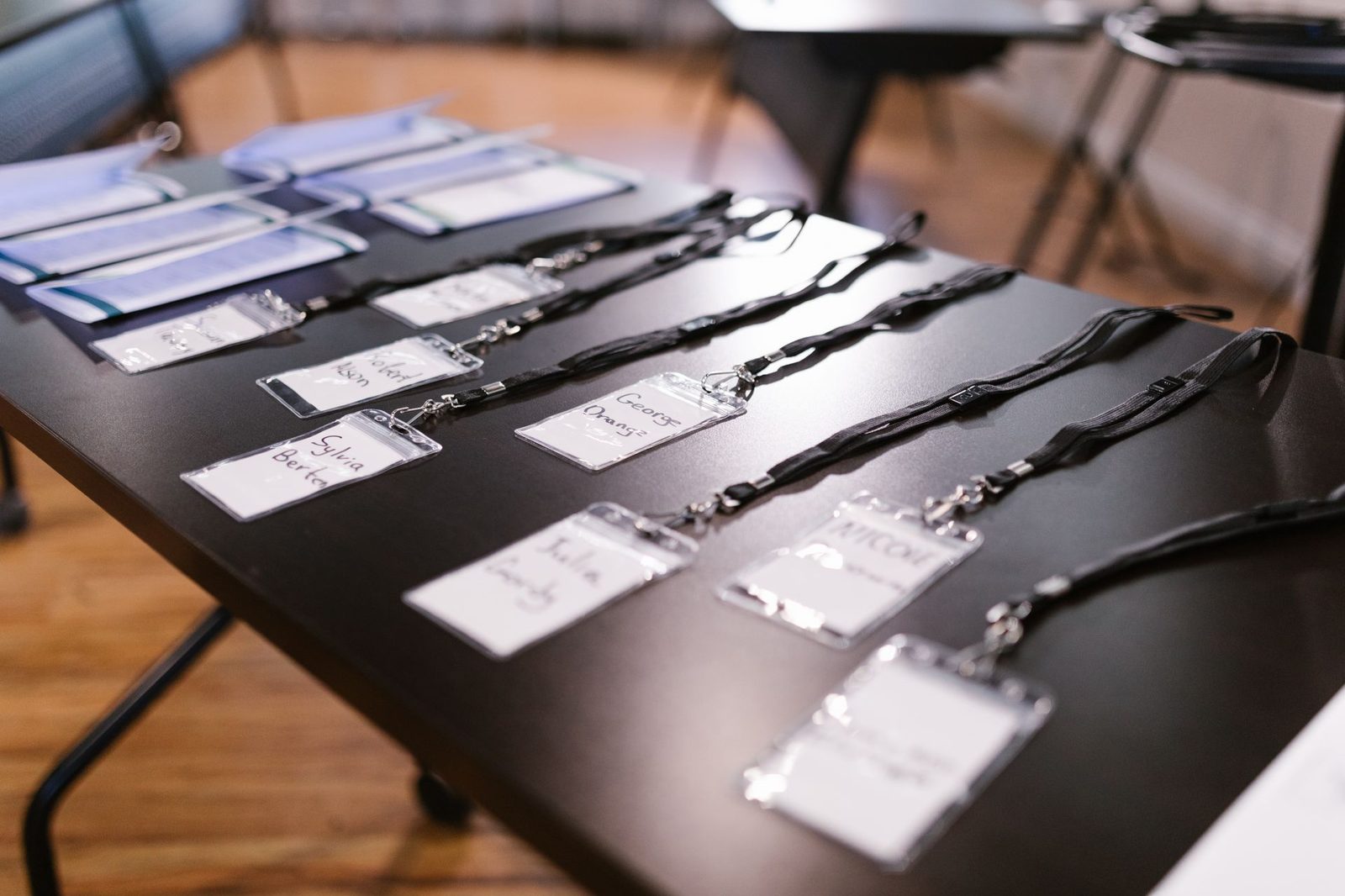 An event registration desk with printed materials and name badges laid out, waiting for arrivals